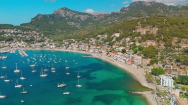 İspanya 'nın Balearic Adaları, Mallorca' daki Port de Soller tatil köyünün havadan görünüşü. İçinde demirli yatlar olan cennet turkuaz bir göl. Mayorka, İspanya.