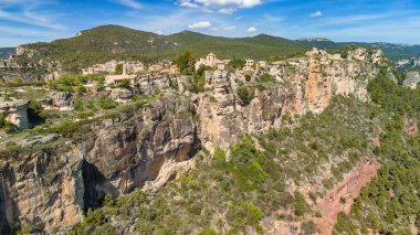 Aerial view of Siurana village perched atop an escarpment in the Prades Mountains, overlooking the Siurana Reservoir in Spain clipart