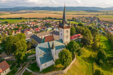 Slovakya 'nın Spissky Stvrtok kasabasındaki eski kilise. Tarihi bir kilise ve yaz boyunca Slovakya 'da küçük bir köy ile geleneksel kırsal manzaranın güzel hava manzarası.