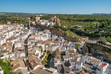 Aerial view of the Setenil de las Bodegas, rustic village with cave houses on a sunny day with blue sky, in the province of Cadiz, Andalusia, Spain. clipart