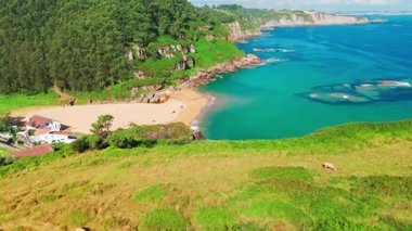 Gijon, Asturias yakınlarındaki inanılmaz Playa de La Nora plajı, kuzey İspanya. Asturias 'ın Cantabrian Denizi kıyısı boyunca turkuaz deniz suyuyla cennet gibi beyaz kumsal manzarası..