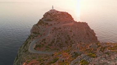 İspanya 'nın Balearic Adaları, Mallorca, Cape Formentor' daki pitoresk deniz fenerinin hava görüntüsü. Güzel, dolambaçlı bir yol, denizin üzerindeki yüksek bir uçuruma tünemiş deniz fenerine çıkar.