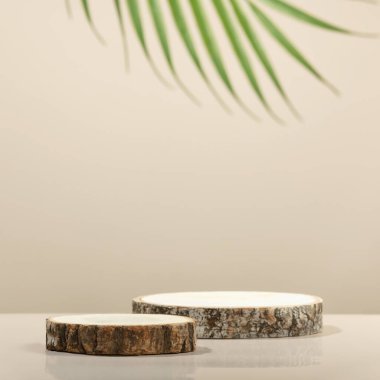 Minimal modern product display on neutral beige background. Wood slice podiums and green leaves. Concept scene stage showcase for new product, promotion sale, banner, presentation, cosmetic