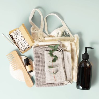 Natural self care products. Zero waste, eco-friendly bathroom and spa accessories with reusable eco bags on pastel blue background, flat lay