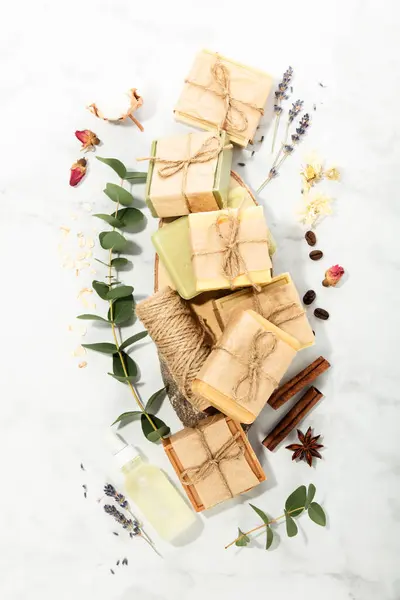 Sustainable lifestyle concept. Bars of natural handmade soap and ingredients on marble background, top view