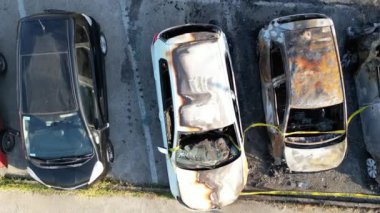 Aerial view of burned cars in a car parking. Terrorist attack and urban danger concept.