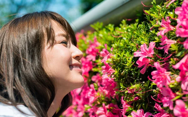 美しい花の匂いがする若い日本人の女の子 — ストック写真