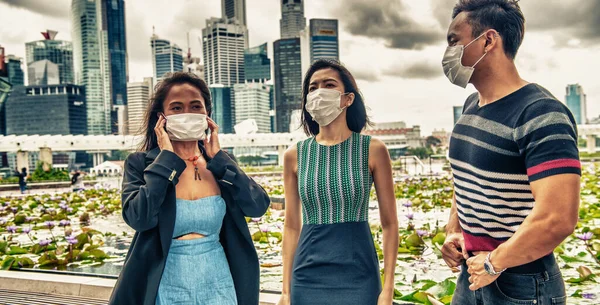 Group of three asian people outdoor wearing face mask.