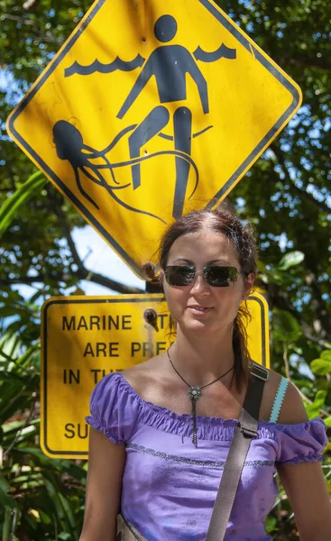 Portrait Happy Caucasian Woman Marine Stingers Warning Sign Background — Stok fotoğraf