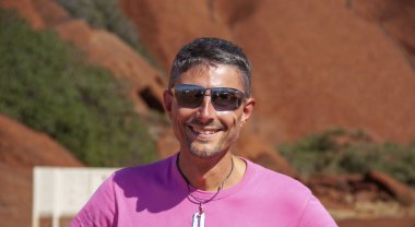 Güzel güneşli bir günde Avustralya kırsalında yürüyüş yapan mutlu bir beyaz adamın portresi..