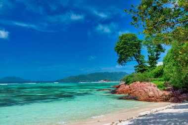 Amazing picturesque paradise beach with granite rocks and white sand, turquoise water on a tropical landscape, Seychelles.