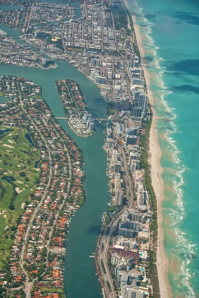 Amazing aerial view of Miami Beach skyline and coastline from a departing airplane.