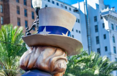 New Orleans, LA - February 9, 2016: Masked people along Mardi Gras Parade in Bourbon Street. Mardi Gras is the biggest celebration the city of New Orleans hosts every year.