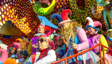Viareggio, Italy - February 10, 2013: People with colorful costumes dancing on a Float at the famous Carnival parade.