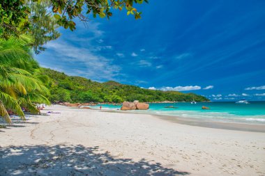 Praslin, Seychelles - September 2017: People along the beautiful beach on a sunny day.
