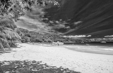 Praslin, Seychelles - September 2017: People along the beautiful beach on a sunny day.