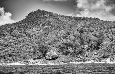 Mountains and vegetation of a beautiful tropical island as seen from the ocean.