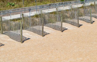 Beach space separators made of wood. Dividers with wooden slats.