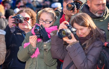 Venice, Italy - February 8, 2015: Crowd of phorographers taking pictures of people masks during the carnival parade.