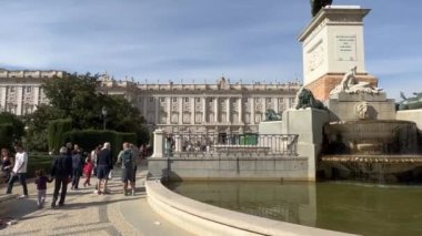 Madrid, Spain - October 29, 2022: Tourists in front of Felipe IV Monument near Royal Palace.