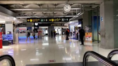 BANGKOK, THAILAND - DECEMBER 16, 2019: Suvarnabhumi International Airports interior with tourists on the treadmills.