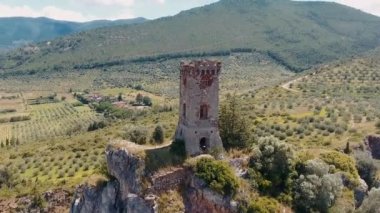 Caprona, Tuscany. Aerial view of famous medieval tower on the mountain top. Slow motion.