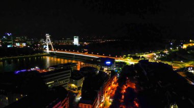 Aerial view of Bratislava city skyline at night from drone, Slovakia.