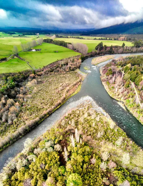 A river forks in two, aerial view of beautiful countryside.