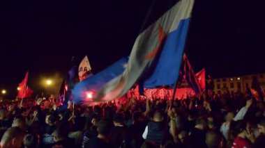 PISA, ITALY - JUNE 15TH, 2016: Celebrations on the night for the soccer teams promotion. People mad with joy in the street.
