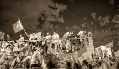 PISA, ITALY - JUNE 15TH, 2016: Local fans celebrate the soccer team's promotion. Celebrations in the night.
