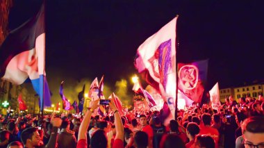 PISA, ITALY - JUNE 15TH, 2016: Local fans celebrate the soccer team's promotion. Celebrations in the night with smoke bombs and an open bus.