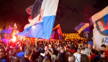 PISA, ITALY - JUNE 15TH, 2016: Local fans celebrate the soccer team's promotion. Celebrations in the night with smoke bombs.