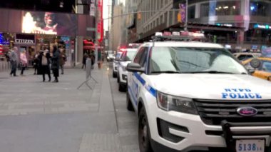 NEW YORK CITY - DECEMBER 2018: Police cars along Times Square, defocused view. The city attracts 50 million visitors every year.