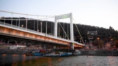 Liberty Bridge at sunset as seen from a moving boat, Budapest.