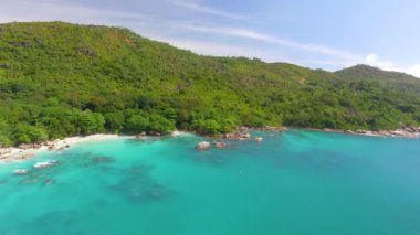 Aerial view of beautiful tropical beach with rocks and trees. Drone viewpoint.