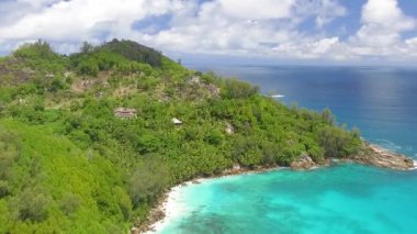 Beautiful aerial view of Seychelles beach and trees from a drone perspective.