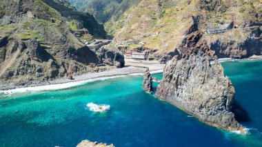 Aerial view of tall lava rocks in ocean, islet towers in Ribeira da Janela, Madeira, Portugal.