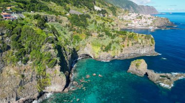 Beautiful wild coast scenery view with Bridal Veil Falls (Veu da noiva) at Ponta do Poiso in Madeira Island. Aerial view.