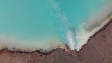 Hot geothermal pool of Hverir Myvatn Lake. Iceland blue water steam, overhead aerial view.