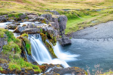 Kirkjufellfoss waterfalls at summer sunset, Iceland.