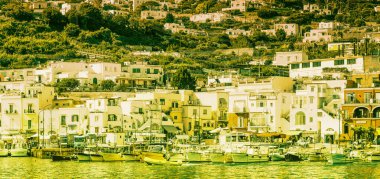 Panoramic view of Capri Island restaurants and shops along the port promenade, Italy.