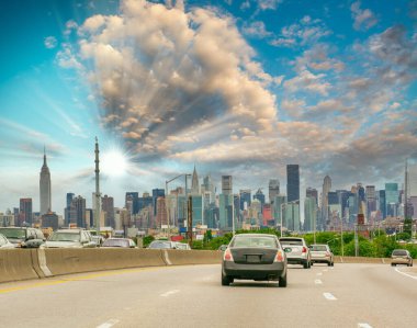 Major road to New York City at sunset. Car traffic at dusk.