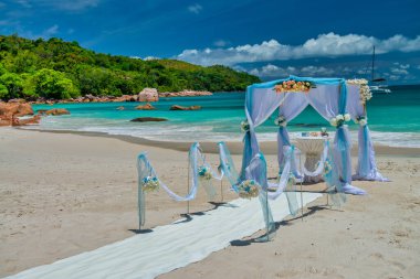 Wedding gazebo setup. Destination wedding on a white sand beach during summer. Exotic wedding on an isolated island. clipart
