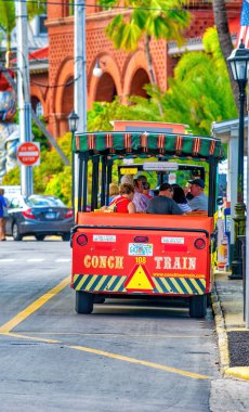 Key West, FL - February 21, 2016: City orange trolley is a famous tourist attraction.