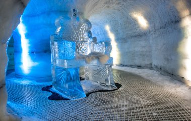 Tunnel made by ice underground with sculptures.