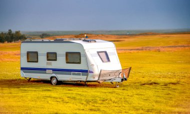 Roulotte on the countryside of Iceland, summer season, white caravan in autumn