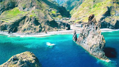 Aerial view of tall lava rocks in ocean, islet towers in Ribeira da Janela, Madeira, Portugal.
