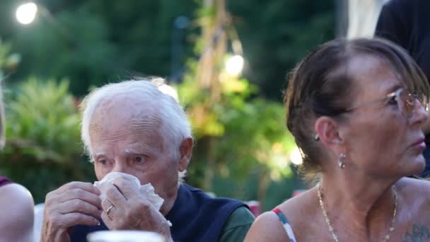 Family Dinner Reunion Outdoor Elderly Man Blows His Nose — Stock Video