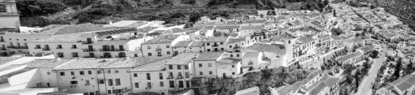 Zahara de la Sierra, Andalusia. Aerial view of whitewashed houses sporting rust-tiled roofs and wrought-iron window bars, Spain