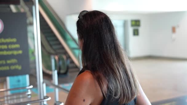 在机场 一个女人坐推车提着手提箱 — 图库视频影像